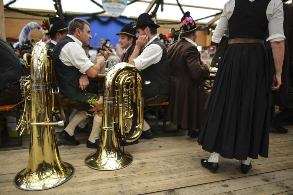 <p>Members of a Bavarian marching band sit next to their tubas. (Getty Images/Philipp Guelland) </p>