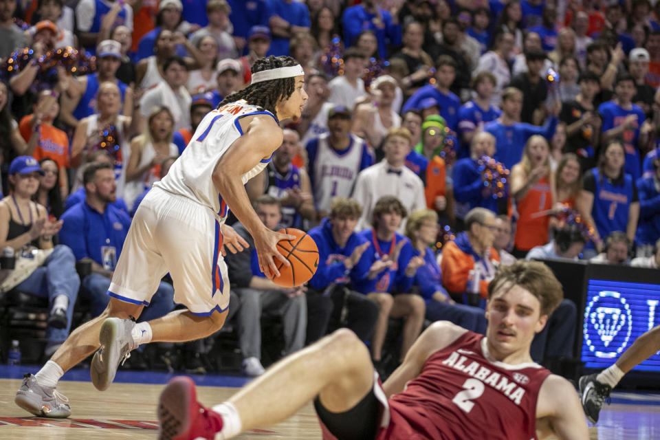 Florida guard Walter Clayton Jr. (1) takes the ball from Alabama forward Grant Nelson (2) during the second half of an NCAA college basketball game Tuesday, March 5, 2024, in Gainesville, Fla. (AP Photo/Alan Youngblood)