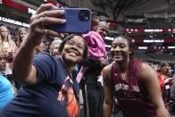 South Carolina's Aliyah Boston takes a selfie with a fan after a practice session for an NCAA Women's Final Four semifinals basketball game Thursday, March 30, 2023, in Dallas. (AP Photo/Tony Gutierrez)