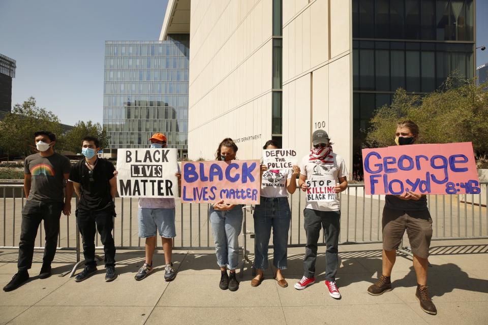 Protesters join a news conference by community activist Najee Ali in front of LAPD Headquarters on June 4.