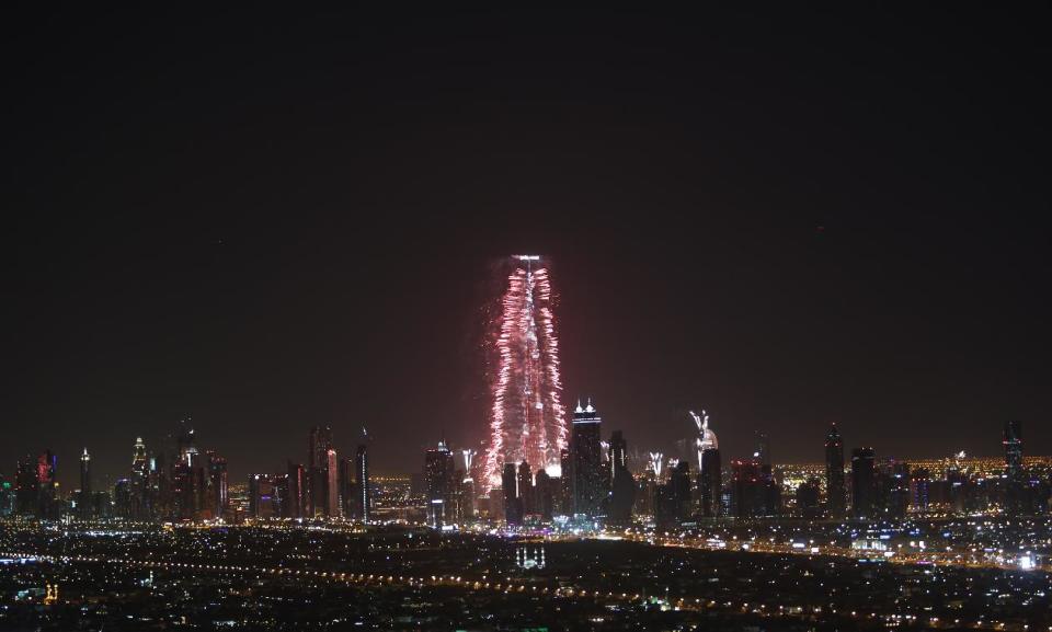 Fireworks errupt from the Burj Khalifa, world's tallest building, at midnight to celebrate the New Year, Wednesday, Jan. 1, 2014, in Dubai, United Arab Emirates. (AP Photo/Kamran Jebreili)