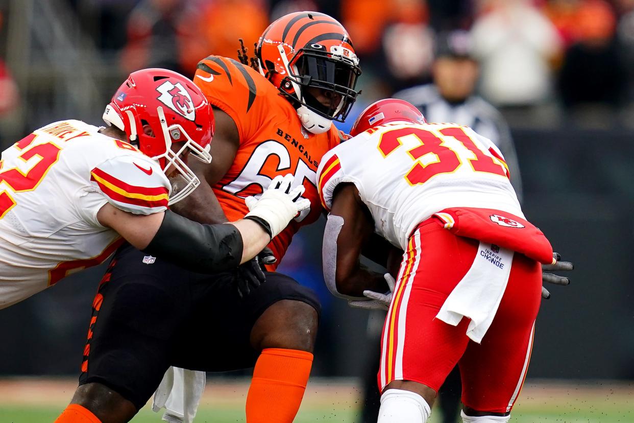 Cincinnati Bengals defensive tackle Larry Ogunjobi (65) tackles Kansas City Chiefs running back Darrel Williams (31) in the first quarter during a Week 17 NFL game, Sunday, Jan. 2, 2022, at Paul Brown Stadium in Cincinnati.