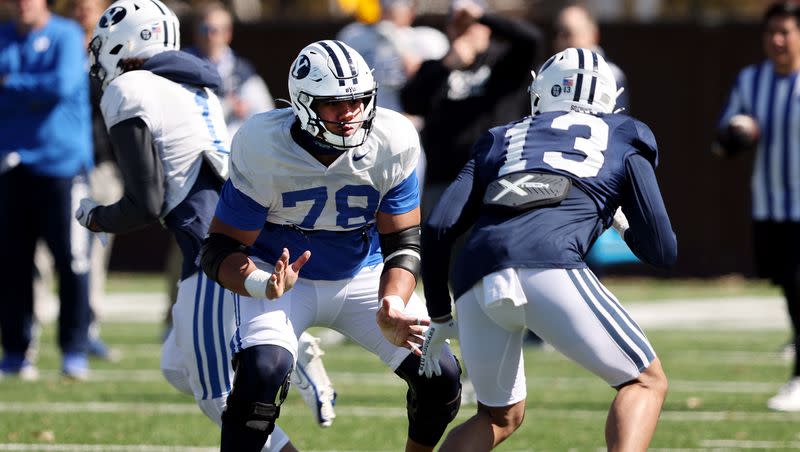 BYU offensive lineman, Kingsley Suamataia blocks defensive end Isaiah Bagnah, as the Cougars practice in Provo on Friday, March 17, 2023.