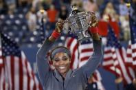 Serena Williams of the U.S. raises her trophy after defeating Victoria Azarenka of Belarus in their women's singles final match at the U.S. Open tennis championships in New York September 8, 2013. REUTERS/Mike Segar