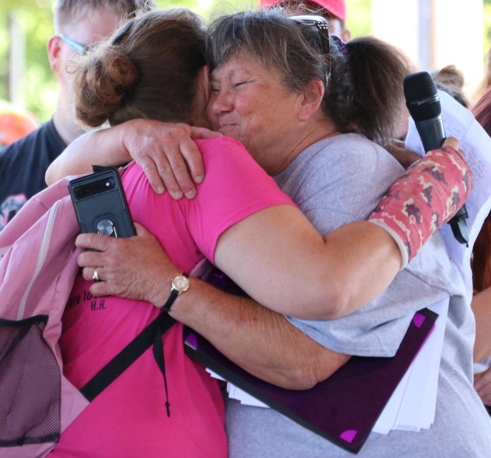 Patricia Perry, of Newark, who helped organize the Aug. 31 event, offers a hug to one of the event speakers.