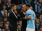 Soccer Football - Premier League - Manchester City vs Everton - Manchester, Britain - August 21, 2017 Manchester City manager Pep Guardiola and Kyle Walker speak with fourth official Michael Oliver as Walker walks off after being sent off REUTERS/Phil Noble
