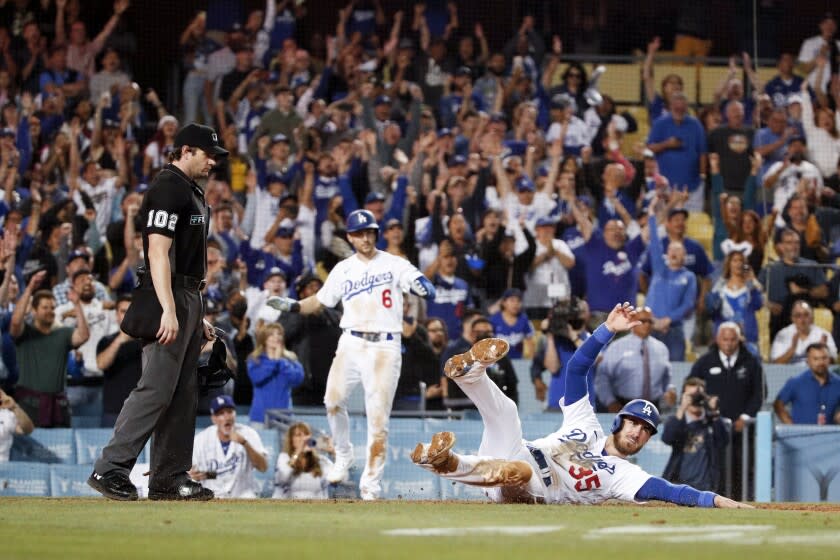 Los Angeles, CA - July 06: Los Angeles Dodgers' Cody Bellinger slides into home to score the game-winning run off an RBI single by LMookie Betts during the ninth inning against the Colorado Rockies at Dodger Stadium on Wednesday, July 6, 2022 in Los Angeles, CA.(Gina Ferazzi / Los Angeles Times)