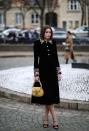 <p>Corrin wears a Miu Miu dress coat to the brand's AW20 show. </p>