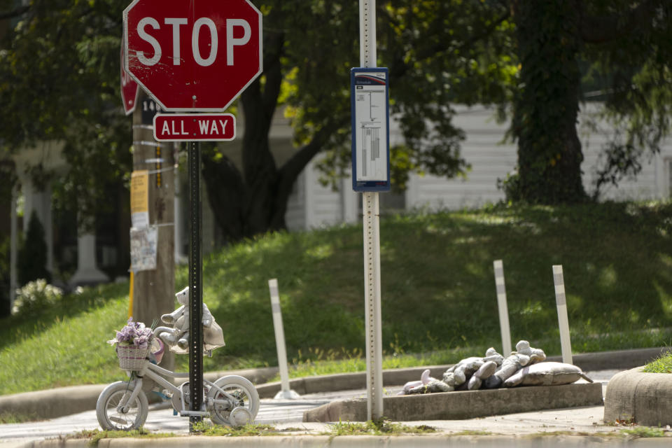 A bicycle painted white serves as a memorial for 5-year-old Allie Hart, who was struck and killed in 2021 by a driver while riding her bicycle in a crosswalk, Monday, Sept. 11, 2023, in Washington. (AP Photo/Mark Schiefelbein)