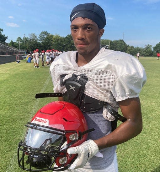 Overton quarterback Kaleb Johnson holds his new helmet, which was purchased through a grant given to the Bobcat program from the Tennessee Titans.