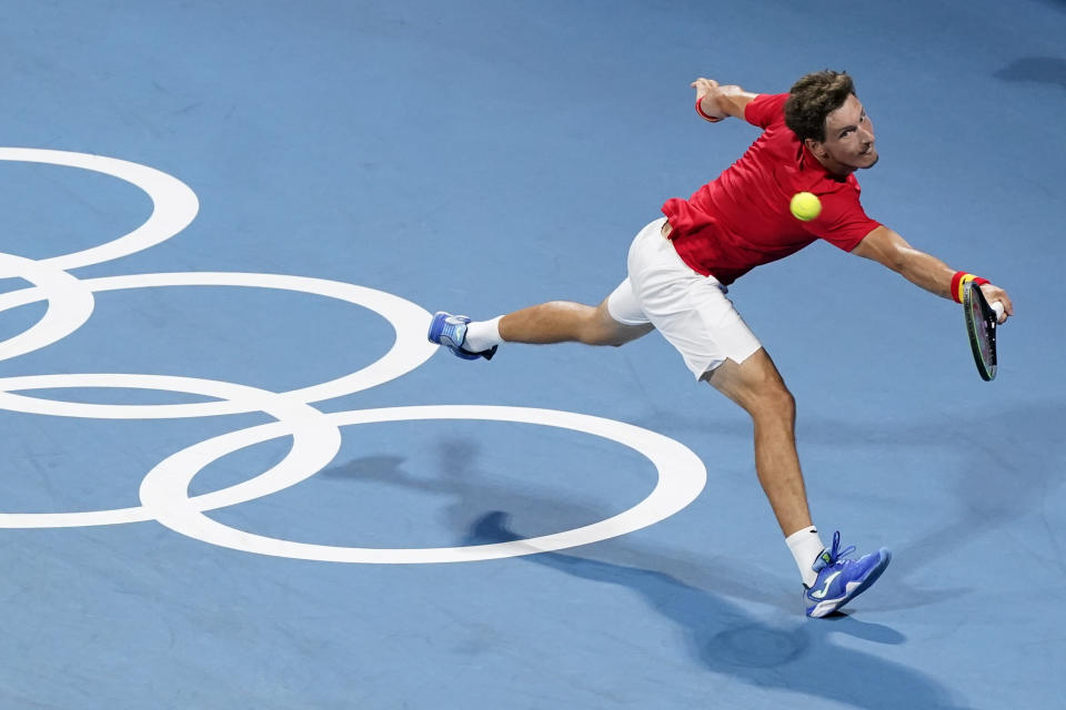 Pablo Carreno Busta, of Spain, returns to Daniil Medvedev, of the Russian Olympic Committee, during the quarterfinal round of the men's tennis competition at the 2020 Summer Olympics, Thursday, July 29, 2021, in Tokyo, Japan. (AP Photo/Patrick Semansky)