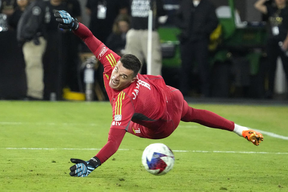 Los Angeles FC goalkeeper Eldin Jakupovic deflects a shot away during the first half of a Major League Soccer match against the Sporting Kansas City Wednesday, May 17, 2023, in Los Angeles. (AP Photo/Mark J. Terrill)