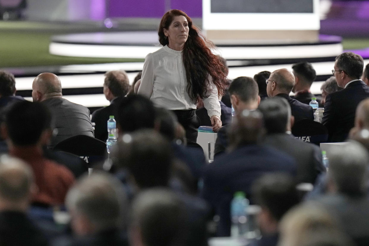 Norwegian soccer official Lise Klaveness walks away after speaking during the FIFA congress at the Doha Exhibition and Convention Center in Doha, Qatar, Thursday, March 31, 2022. (AP Photo/Hassan Ammar)