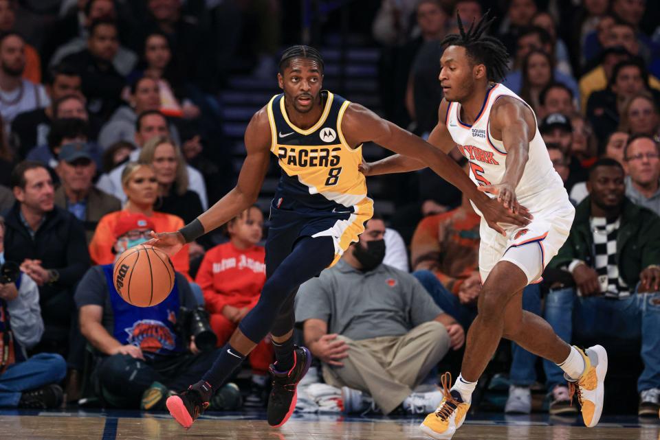 Nov 15, 2021; New York, New York, USA; Indiana Pacers forward Justin Holiday (8) dribbles as New York Knicks guard Immanuel Quickley (5) defends during the second half at Madison Square Garden.