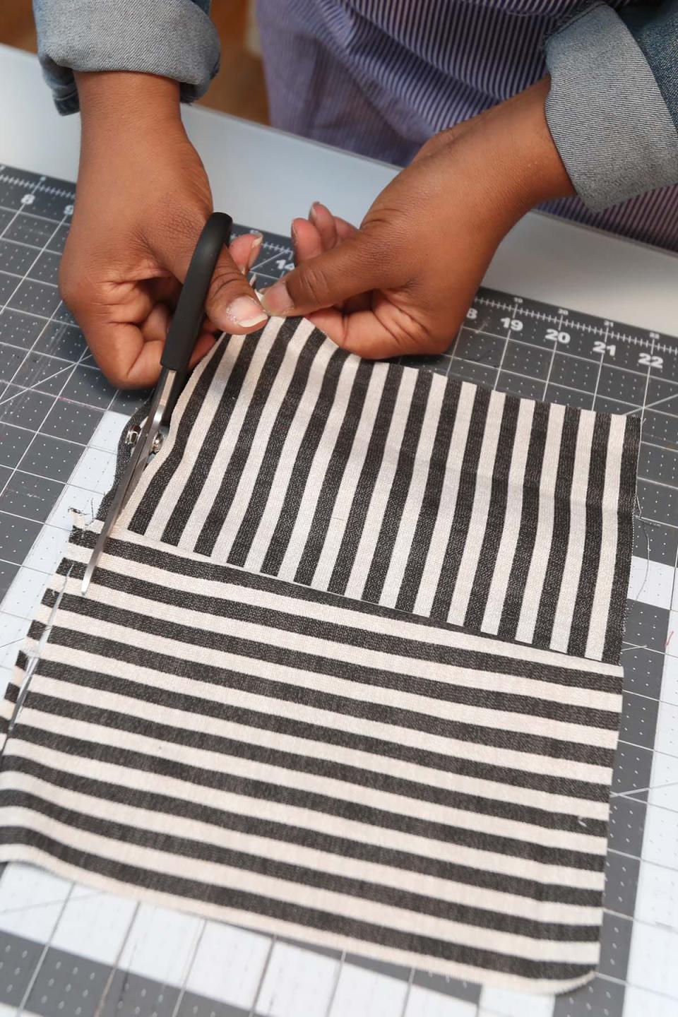 Da'Shika Street cuts fabric to make a pillow Monday in Akron. Street has an e-commerce business where she sells clothes and home goods made out of African fabrics.