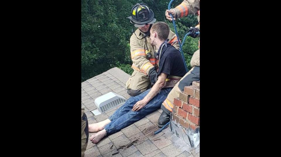 A barefoot Cody Methanial Sargent sits atop a house after trying to escape police through a chimney. Photo from Vanderburgh County Sheriff’s Office.