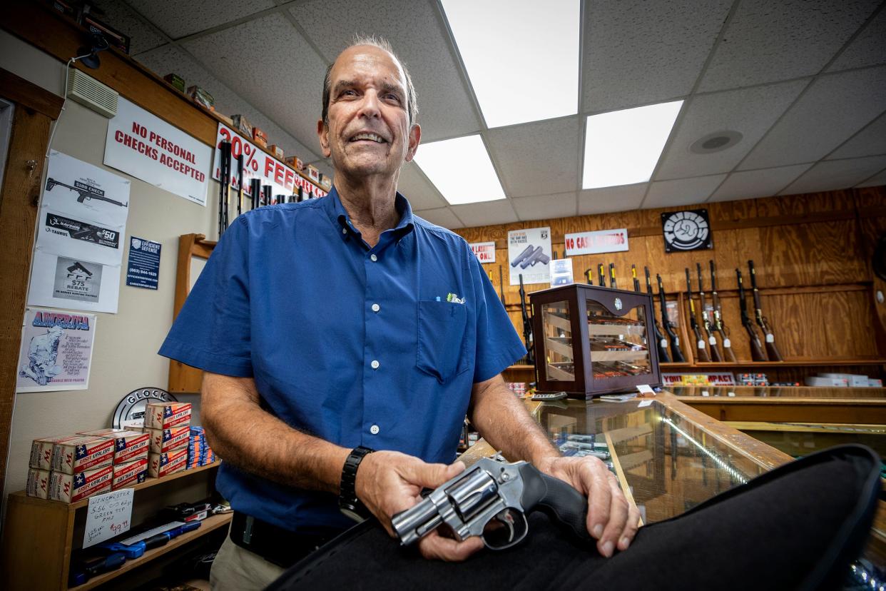 Al Delatorre, owner of Guns Galore in Lakeland, with a Smith & Wesson snub nose revolver that shoots both .38 and .357 caliber. "Now that there's no need to have permit to carry concealed, people think it applies to buying a gun. It doesn't," he said. "You still have a three-day wait."