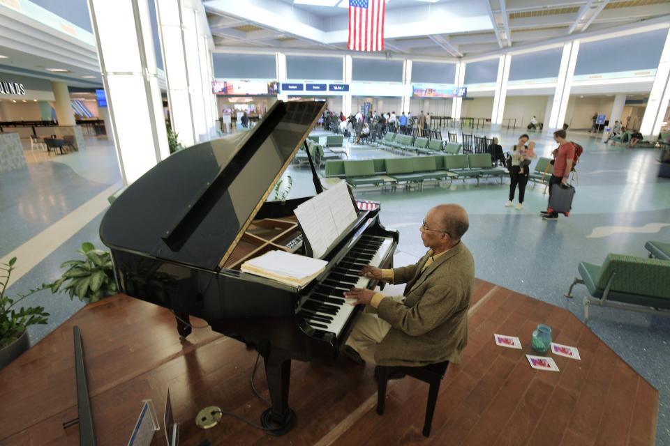 Volunteer pianist Eustache Mathurin entertains passengers as they pass through the main concourse of Jacksonville International Airport Jan. 25.