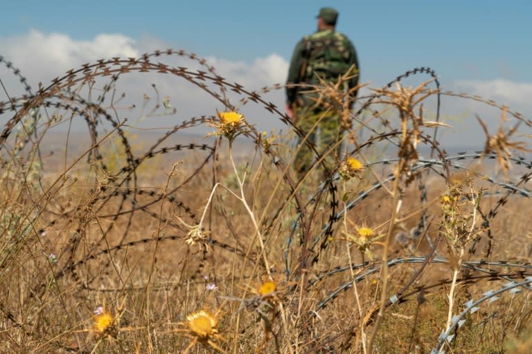 A member of the Syrian government forces patrols near the village of Tal Krum in the Syrian Golan Heights on August 14, 2018