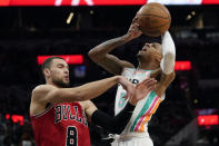 San Antonio Spurs guard Dejounte Murray (5) drives to the basket against Chicago Bulls guard Zach LaVine (8) during the first half of an NBA basketball game, Friday, Jan. 28, 2022, in San Antonio. (AP Photo/Eric Gay)