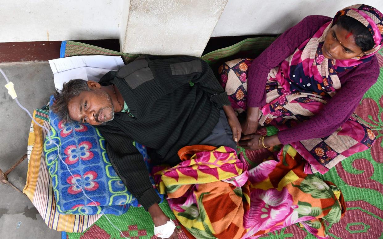 An Indian patient who drank toxic bootleg alcohol is treated at Kushal Konwar Civil Hospital in Golaghat district in the northeastern Indian state of Assam  - AFP