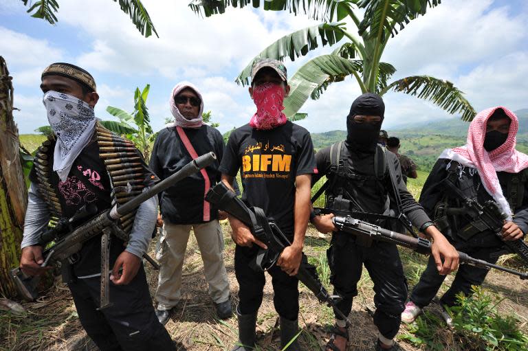 FILE PHOTO: Members of the breakaway Muslim separatist group Bangsamoro Islamic Freedom Fighters (BIFF) stand guard during a clandestine press conference in the town of Datu Unsay, sothern Maguindanao province in the Philippines, on August 28, 2011. (AFP News)