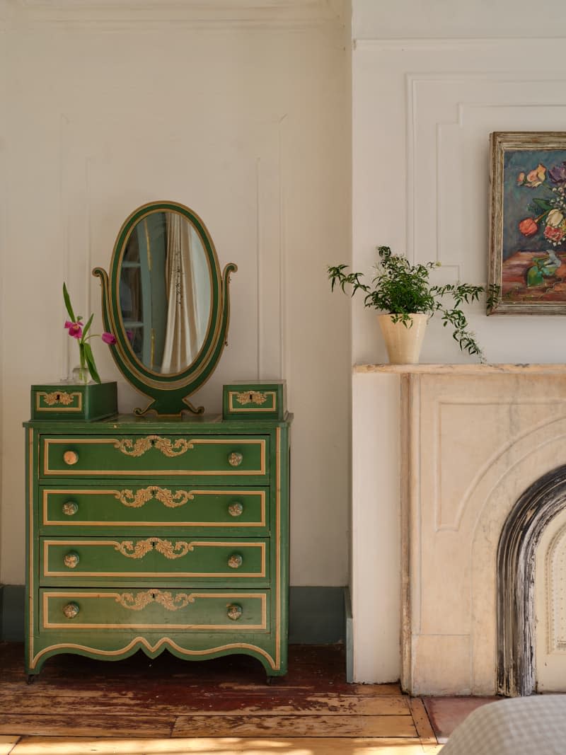 Vintage green painted dresser in bedroom of renovated townhome.