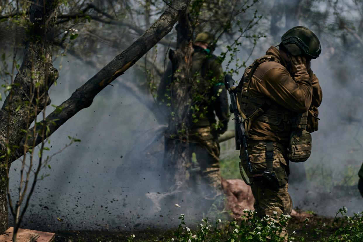 Ukrainian soldiers prepare to fire a cannon in Bakhmut, in the Donetsk region (AP)