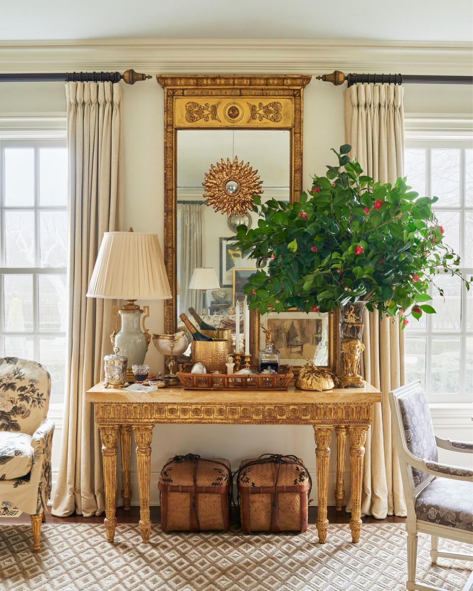 a fancy living room with a large mirror and a table