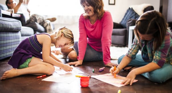 girls coloring with mother