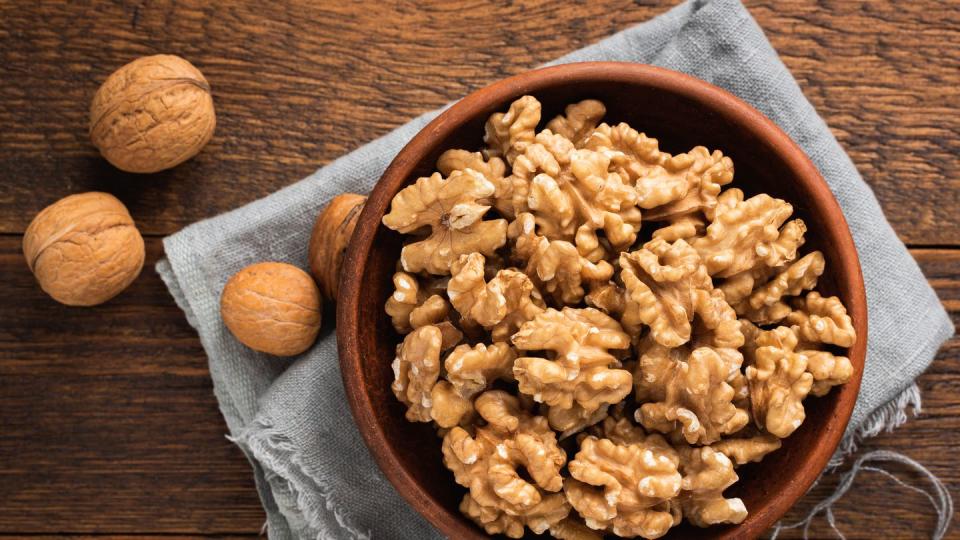 walnuts in bowl on wooden background