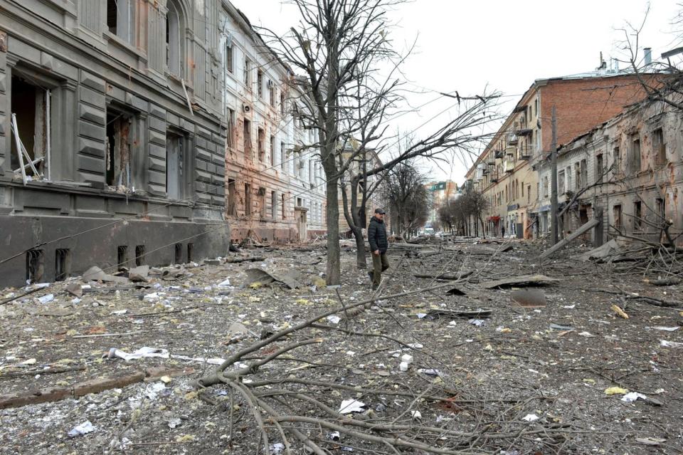 A pedestrian walks amid debris in a street following the shelling in Ukraine's second-biggest city of Kharkiv on March 7, 2022. (Sergey Bobok/AFP via Getty Images)