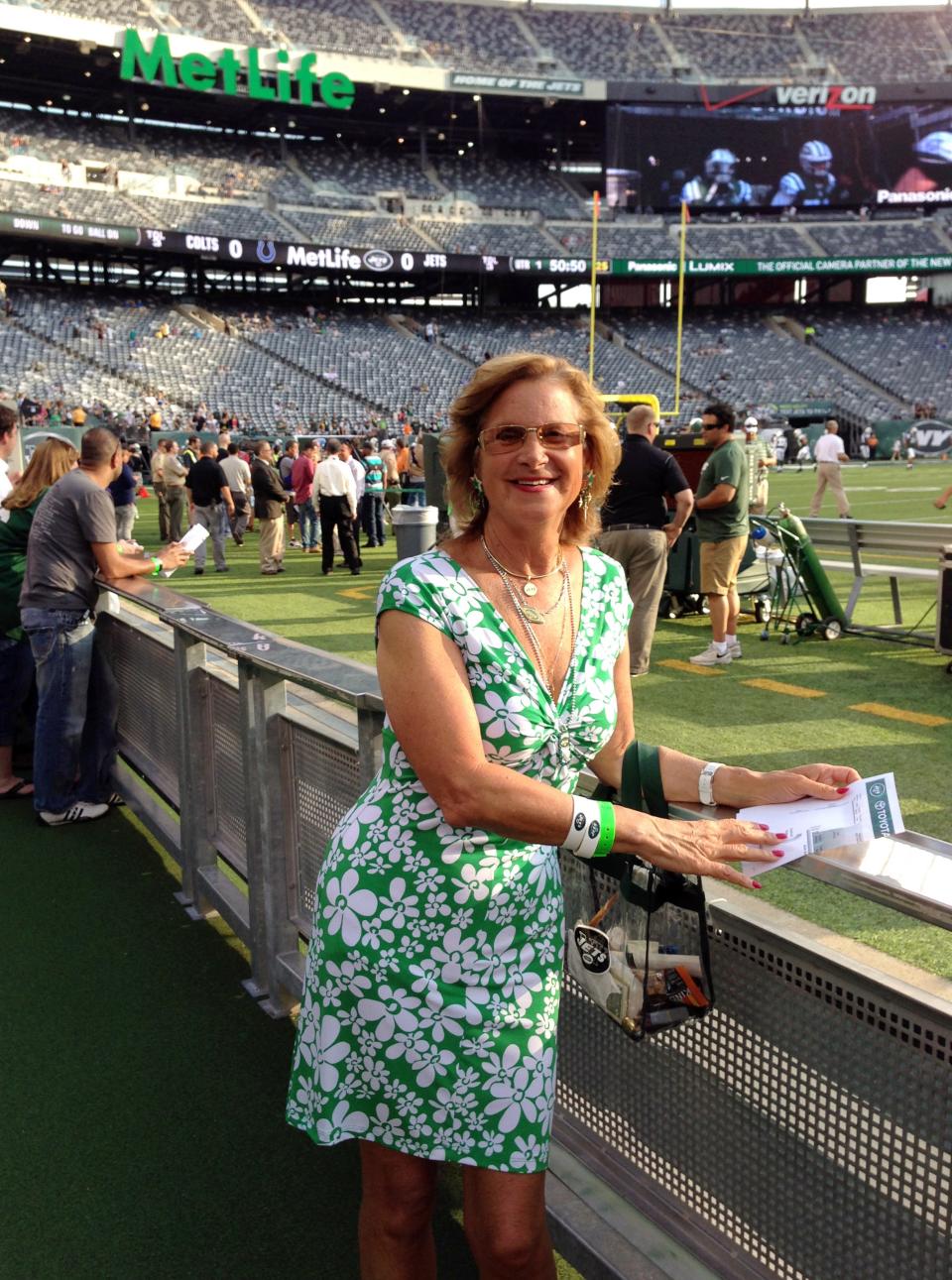 In this photo taken Aug. 7, 2014, Connie Carberg, who served as a scout for the New York Jets from 1976 to 1980, poses near the sideline at MetLife Stadium in East Rutherford, N.J.