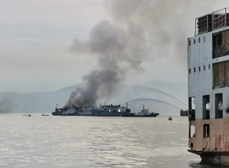 In this handout photo provided by the Philippine Coast Guard, smoke is seen from the M/V Asia Philippines, an inter-island cargo and passenger vessel, as it caught fire while it was approaching Batangas port, southern Philippines on Friday Aug. 26, 2022. A Philippine ferry carrying 82 passengers and crew caught fire as it was approaching a port south of Manila on Friday. coast guard officials said. Most of the passengers and crew have been rescued while search operations continue for the others missing. (Philippine Coast Guard via AP)