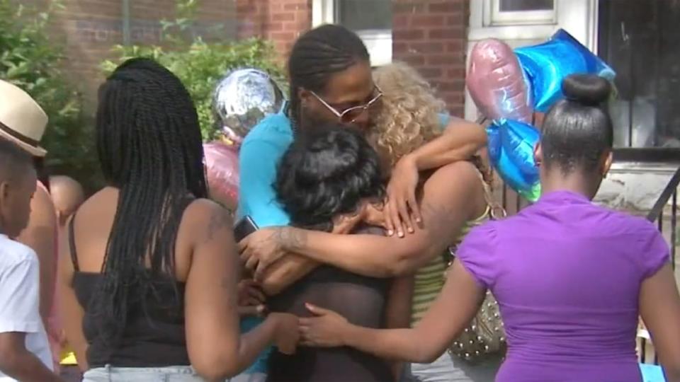 <div class="inline-image__caption"><p>People gather outside the home where Latoya Jackson and her sons Andrew, 11, Kameron, 9, and Kantrell, 5, were found dead on July 18, 2015 in Chicago.</p></div> <div class="inline-image__credit">WLS-TV</div>