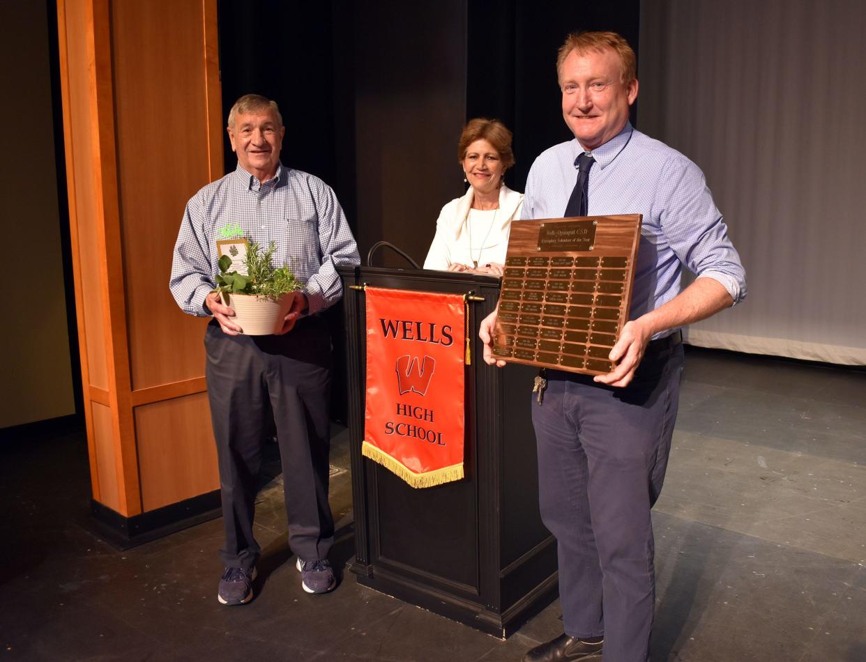 Left to right: Paul Goyette, Maryanne Foley, and Andrew Lopez.  “He takes the time and effort to form relationships with the kids, earning their love and respect,” commented Director Lopez on Paul Goyette.   In the photo Lopez is holding a plaque that contains the names of previous recipients of the Exemplary Volunteer of the Year Award.