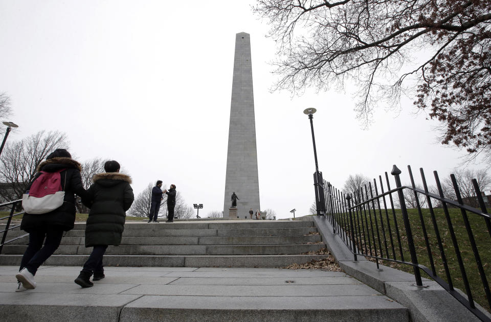 Visitors approach the Bunker Hill Monument, Monday, Dec. 24, 2018, in Boston. The historic site, erected to commemorate the Revolutionary War Battle of Bunker Hill, and run by the National Park Service, was closed Monday due to a partial federal government shutdown. The federal government is expected to remain partially closed past Christmas Day in a protracted standoff over President Donald Trump's demand for money to build a border wall with Mexico. (AP Photo/Steven Senne)