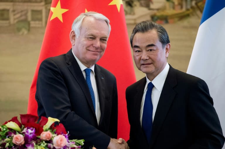 French Foreign Minister Jean-Marc Ayrault (left) is in Beijing for talks with his Chinese counterpart Wang Yi