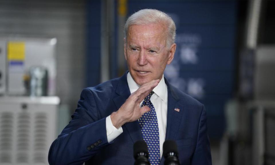 Joe Biden gesturing as he makes a speech, dresed in a dark blue suit and tie