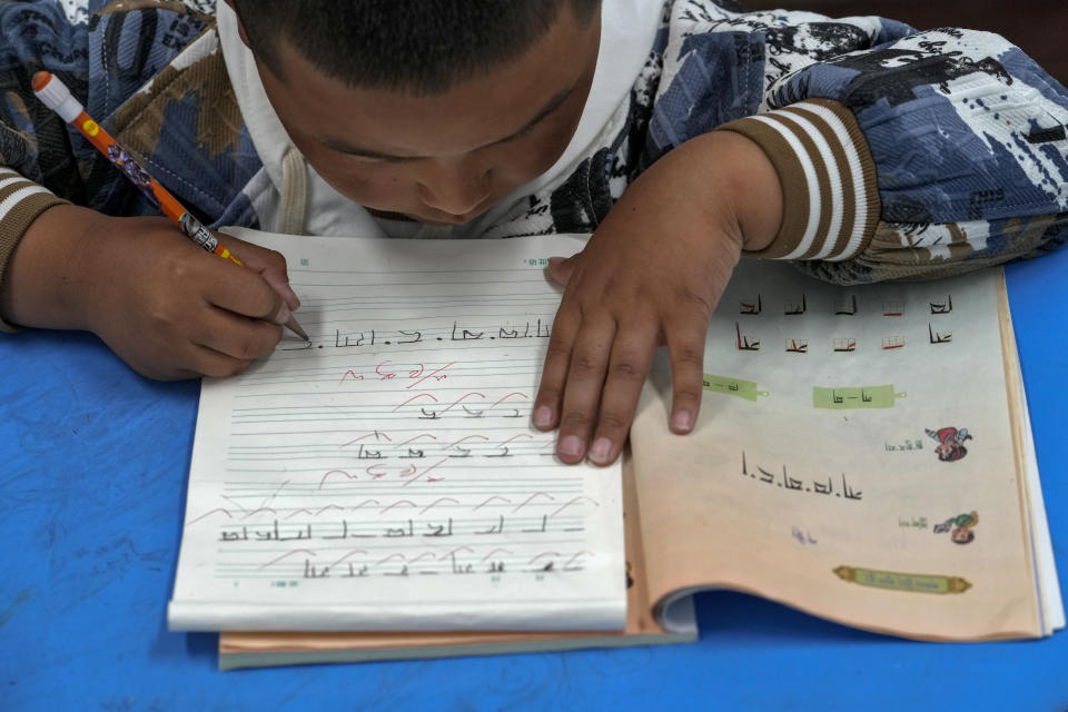 A Tibetan student learns to write Tibetan words in a first-grade class at the Shangri-La Key Boarding School during a media-organized tour in Dabpa county, Kardze Prefecture, Sichuan province, China on Sept. 5, 2023. (AP Photo/Andy Wong)