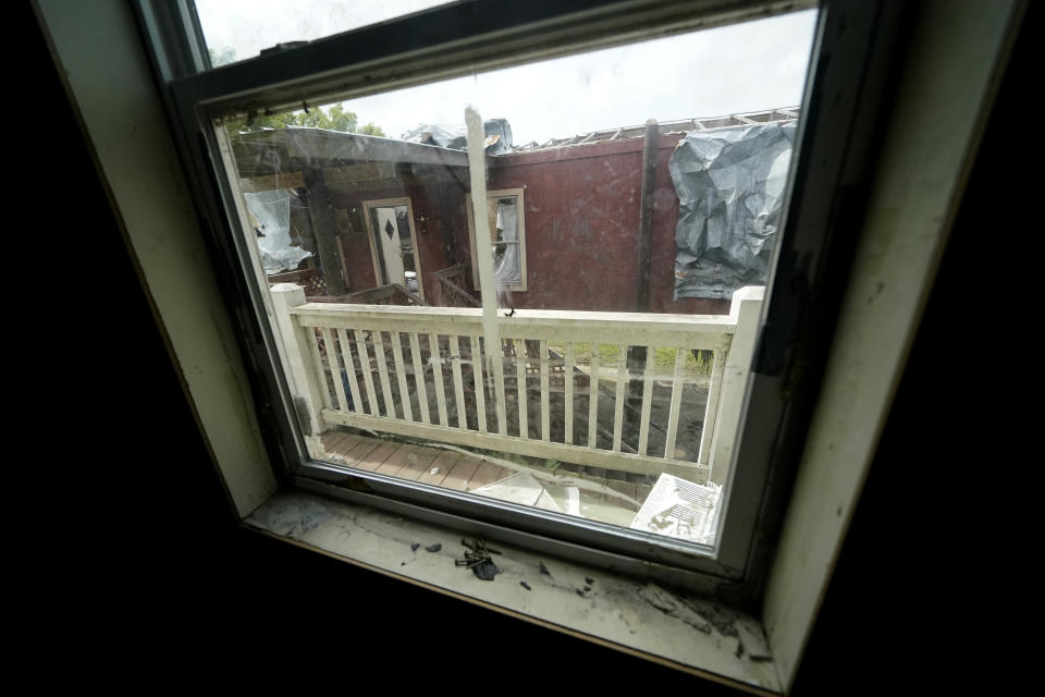 A view from Lester Naquin's home that was heavily damaged by Hurricane Ida nine months before, shows the destroyed home of his nephew, who lived next door with his wife and child, along Bayou Pointe-au-Chien, La., Tuesday, May 24, 2022. (AP Photo/Gerald Herbert)