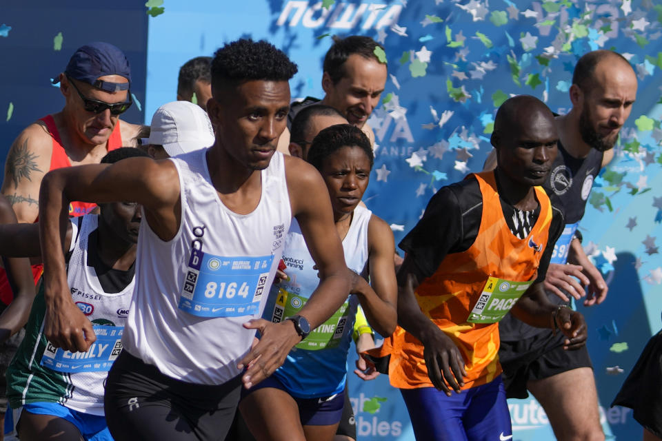 Tachlowini Gabriyesos, Eritrean born long distance runner, left, runs during the half marathon race in Belgrade, Serbia, Sunday, April 23, 2023. Gabriyesos fled his native Eritrea and walked through the desert to reach Israel when he was just 12 years old. He is now running marathons, sending a message of hope and endurance to all refugees like himself. (AP Photo/Darko Vojinovic)