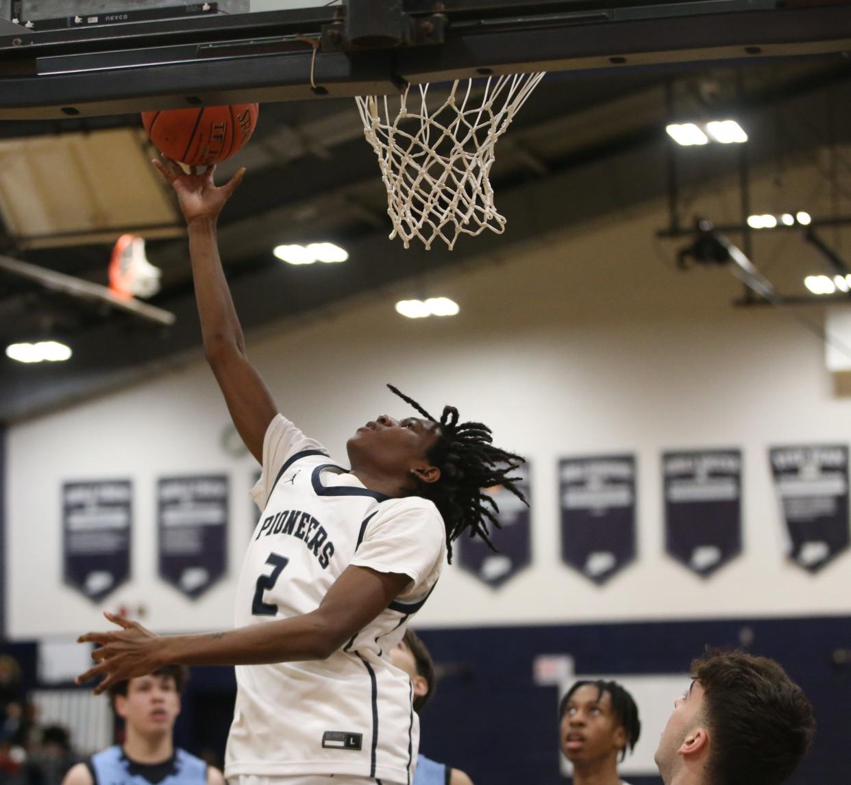 Poughkeepsie's Prince Boone goes for a layup over John Jay's defense during a game on January 10, 2024.