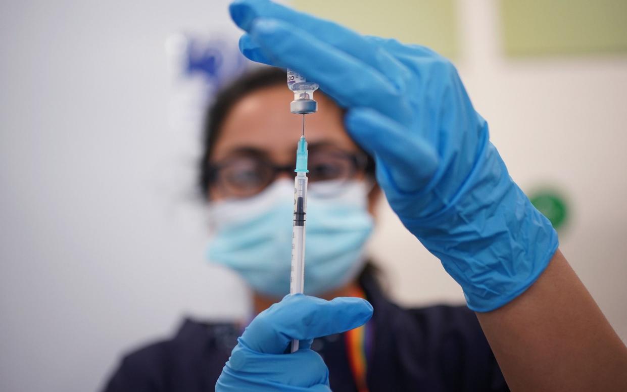 A nurse preparing a booster shot in east London. The study from Imperial and Queen Mary University of London showed that people become ‘imprinted’ with a specific immune profile after encountering coronavirus - Yui Mok/PA Wire