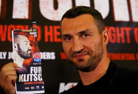 Britain Boxing - Tyson Fury & Wladimir Klitschko Head-to-Head Press Conference - Landmark London Hotel - 12/9/16 Wladimir Klitschko poses with an image of Tyson Fury during the press conference Action Images via Reuters / Peter Cziborra Livepic