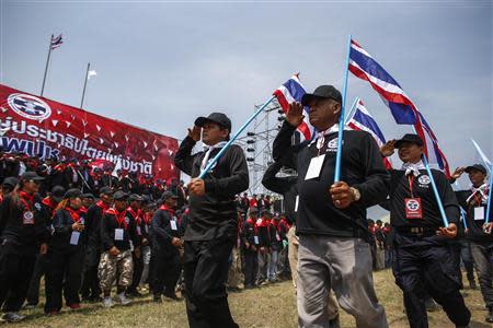 Members of the "Volunteers' Ward to protect the Nation's Democracy" group take part during a march marking the end of their two days training at the stadium in Nakhon Ratchasima, Northeastern province of Thailand, April 21, 2014. REUTERS/Athit Perawongmetha