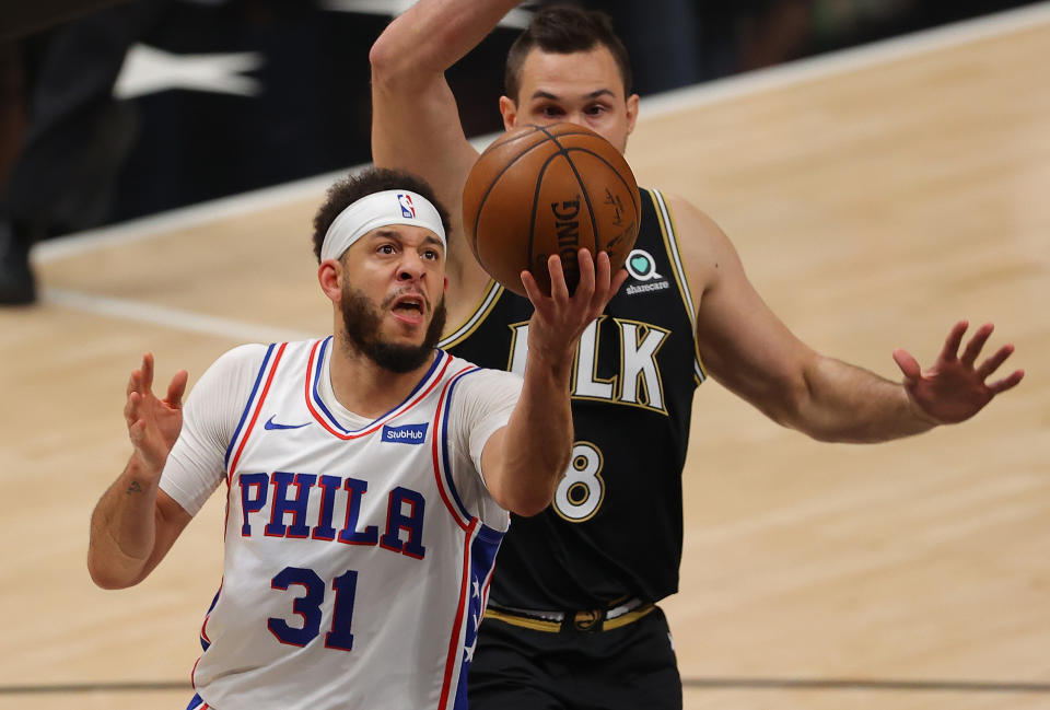 ATLANTA, GEORGIA - JUNE 18:  Seth Curry #31 of the Philadelphia 76ers drives against Danilo Gallinari #8 of the Atlanta Hawks during the first half of game 6 of the Eastern Conference Semifinals at State Farm Arena on June 18, 2021 in Atlanta, Georgia.  NOTE TO USER: User expressly acknowledges and agrees that, by downloading and or using this photograph, User is consenting to the terms and conditions of the Getty Images License Agreement. (Photo by Kevin C. Cox/Getty Images)