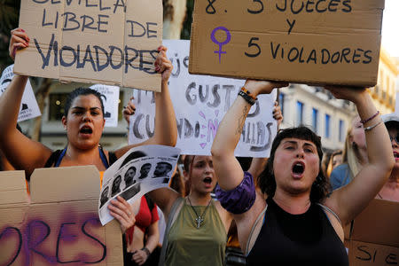 Protesters chant slogans during a demonstration against the release on bail of five men known as the "Wolf Pack" cleared of gang rape of a teenager and convicted of a lesser crime of sexual abuse in Seville, Spain, June 22, 2018. REUTERS/Marcelo del Pozo