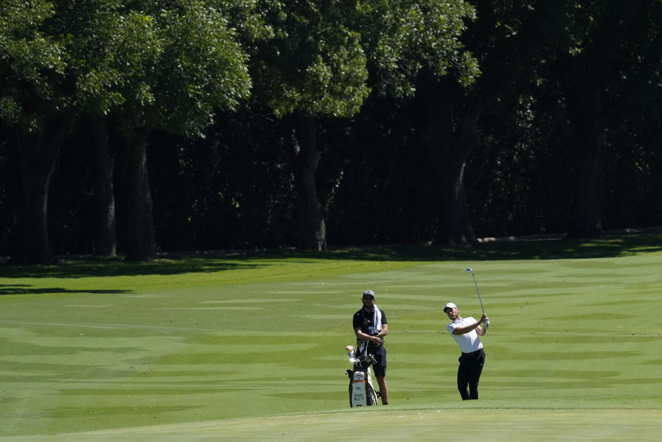 Danny Willett, of England, hits to the 12th green during practice for the Charles Schwab Challenge golf tournament at the Colonial Country Club in Fort Worth, Texas, Wednesday, June 10, 2020. (AP Photo/David J. Phillip)