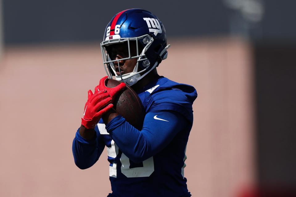 EAST RUTHERFORD, NEW JERSEY - MAY 30: Devin Singletary #26 of the New York Giants runs the ball during OTA Offseason Workouts at NY Giants Quest Diagnostics Training Center on May 30, 2024 in East Rutherford, New Jersey. (Photo by Luke Hales/Getty Images)